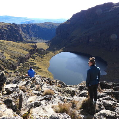 Two trekkers at the Lake Michaelson cliff viewpoint above the Gorges Valley on the 4-day Mount Kenya private trek Chogoria–Sirimon Route