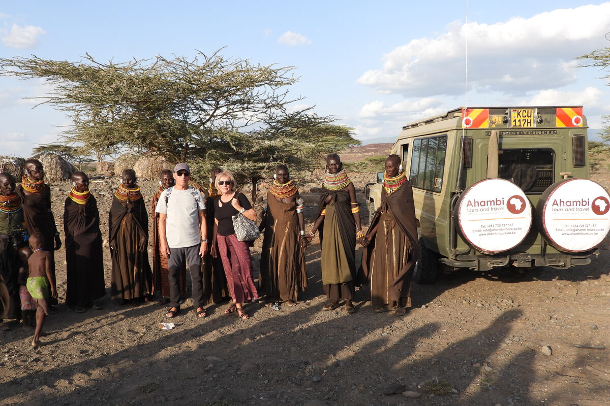 Ahambi Tours guests with Turkana community members during a Northern Kenya safari cultural village visit — a highlight of the Northern Kenya safari experience